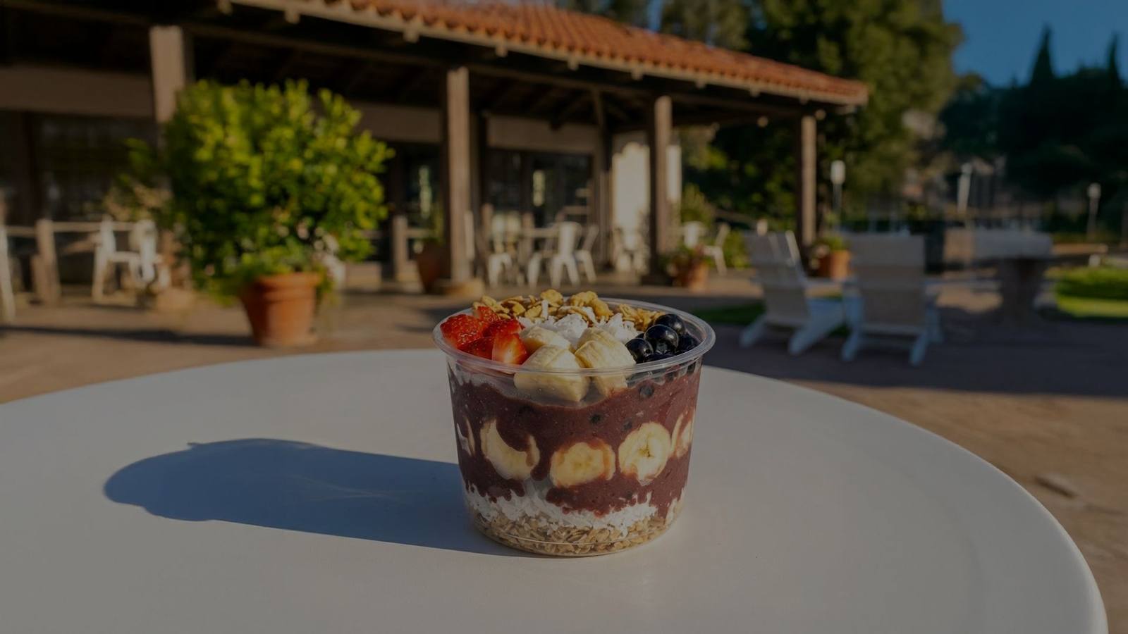 Layered açaí cup on a table outside the shop